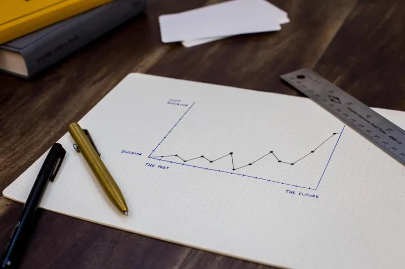 Hand-drawn growth chart on paper next to pens and a ruler